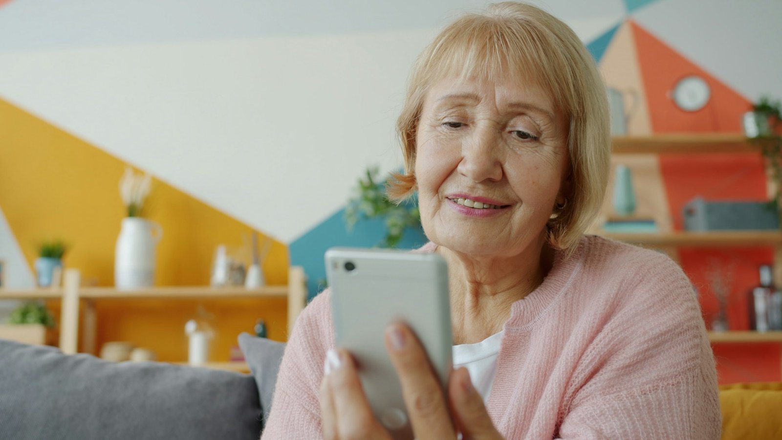 Older woman smiling at her phone